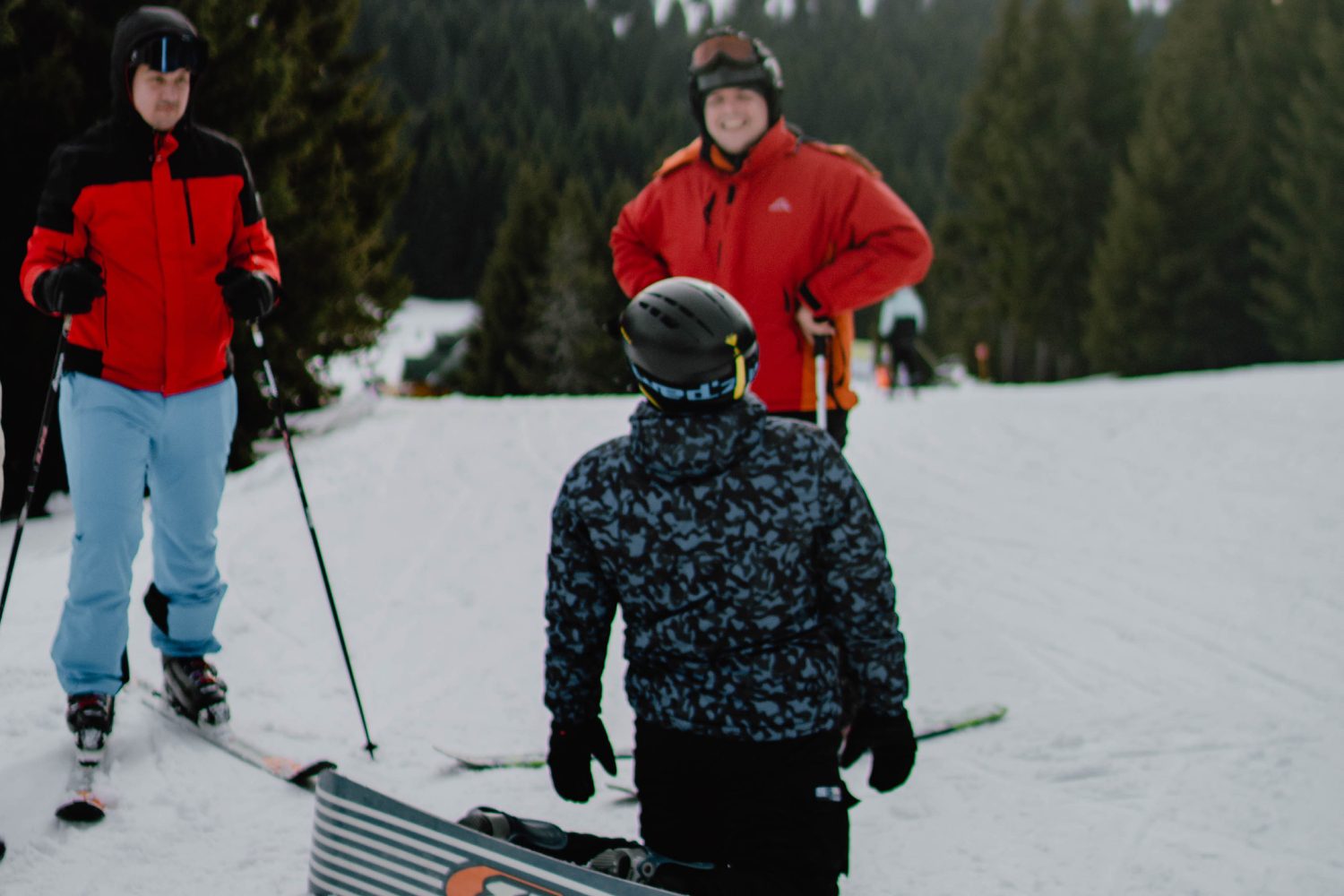 full shot people skiing together